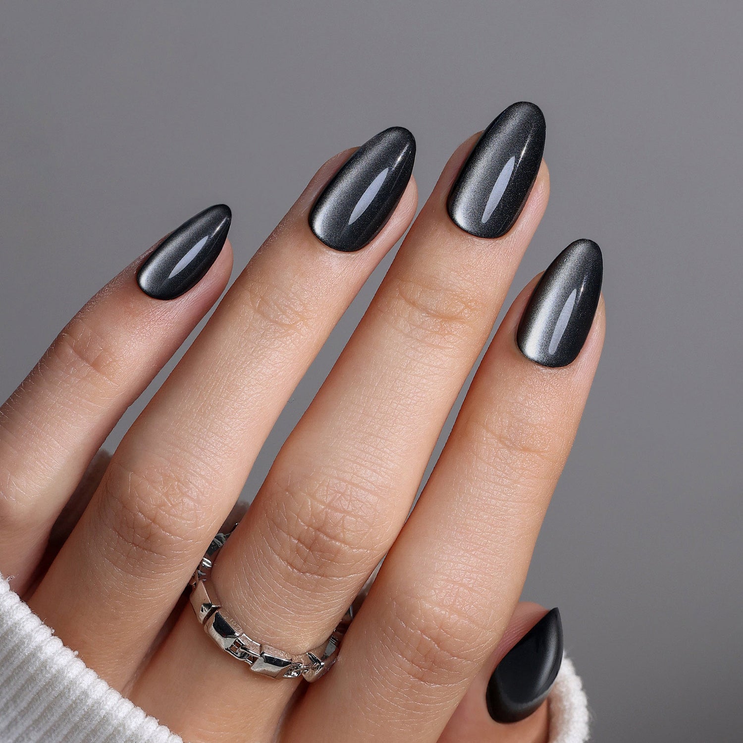 Galaxy-Like Black Cat Eye Almond Nails