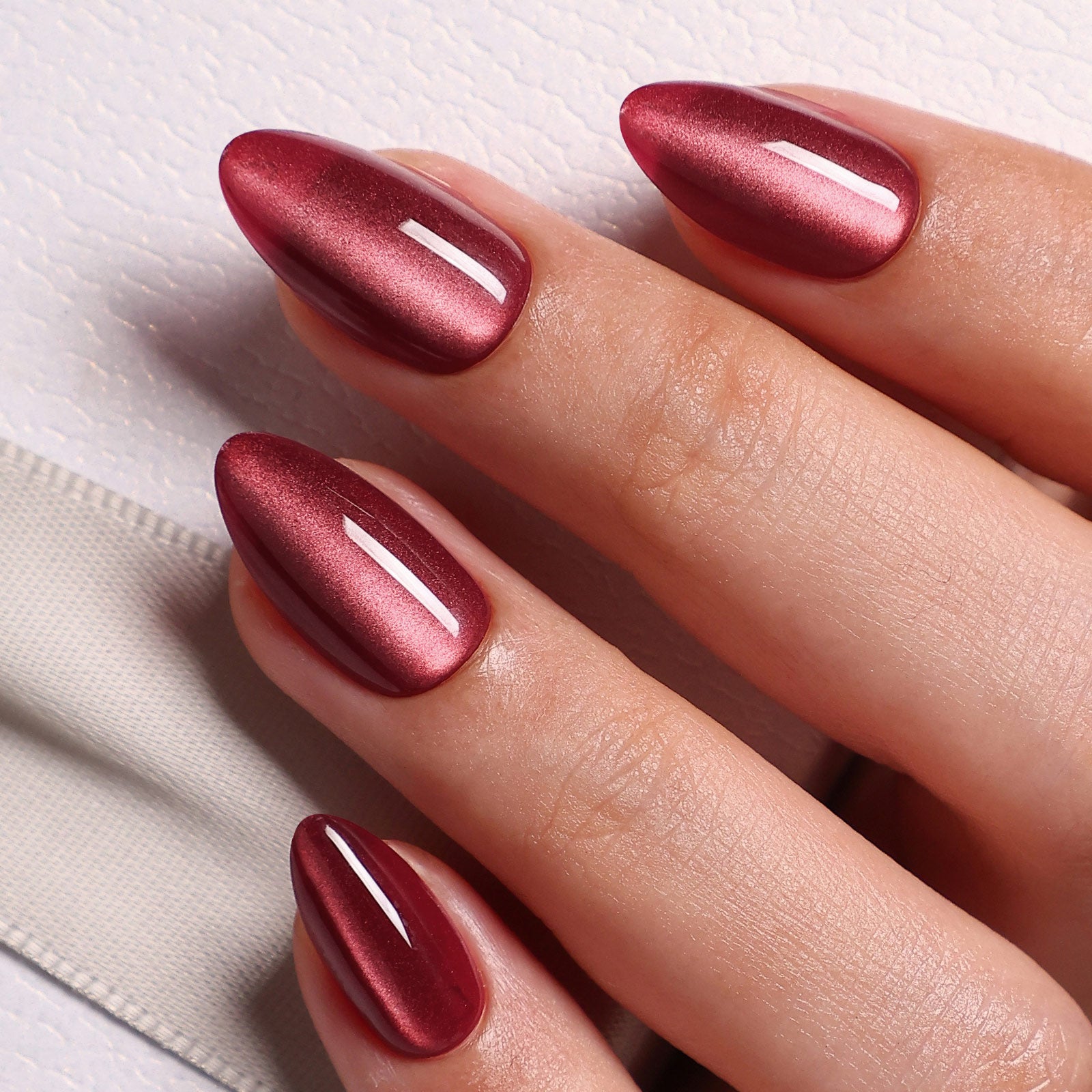 Cat Eye Burgundy Long Almond Soft Gel Press-On Nails cat-eye finish close-up on hand | SHANGMENG®