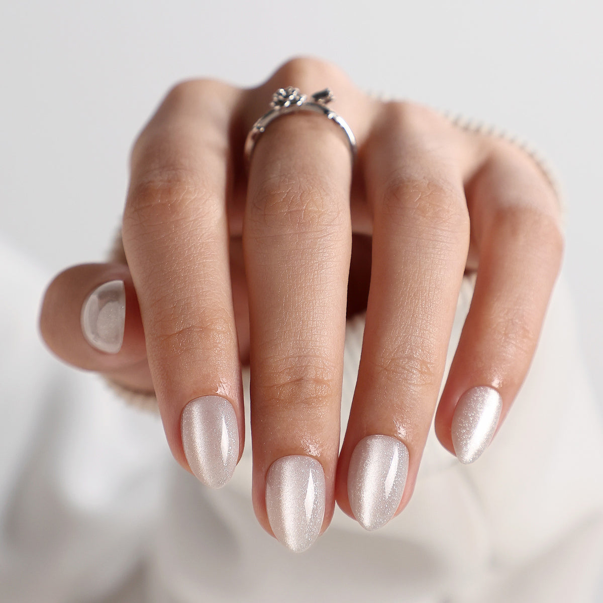 Cat Eye Pearl White Short Almond Soft Gel Press-On Nails glossy finish close up on hand | SHANGMENG®