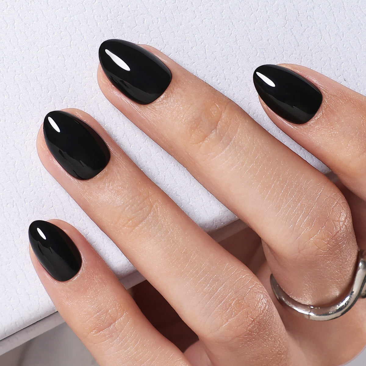 Chic Black High Gloss — Extra Short Almond angled close-up of glossy black extra short almond nails | SHANGMENG®