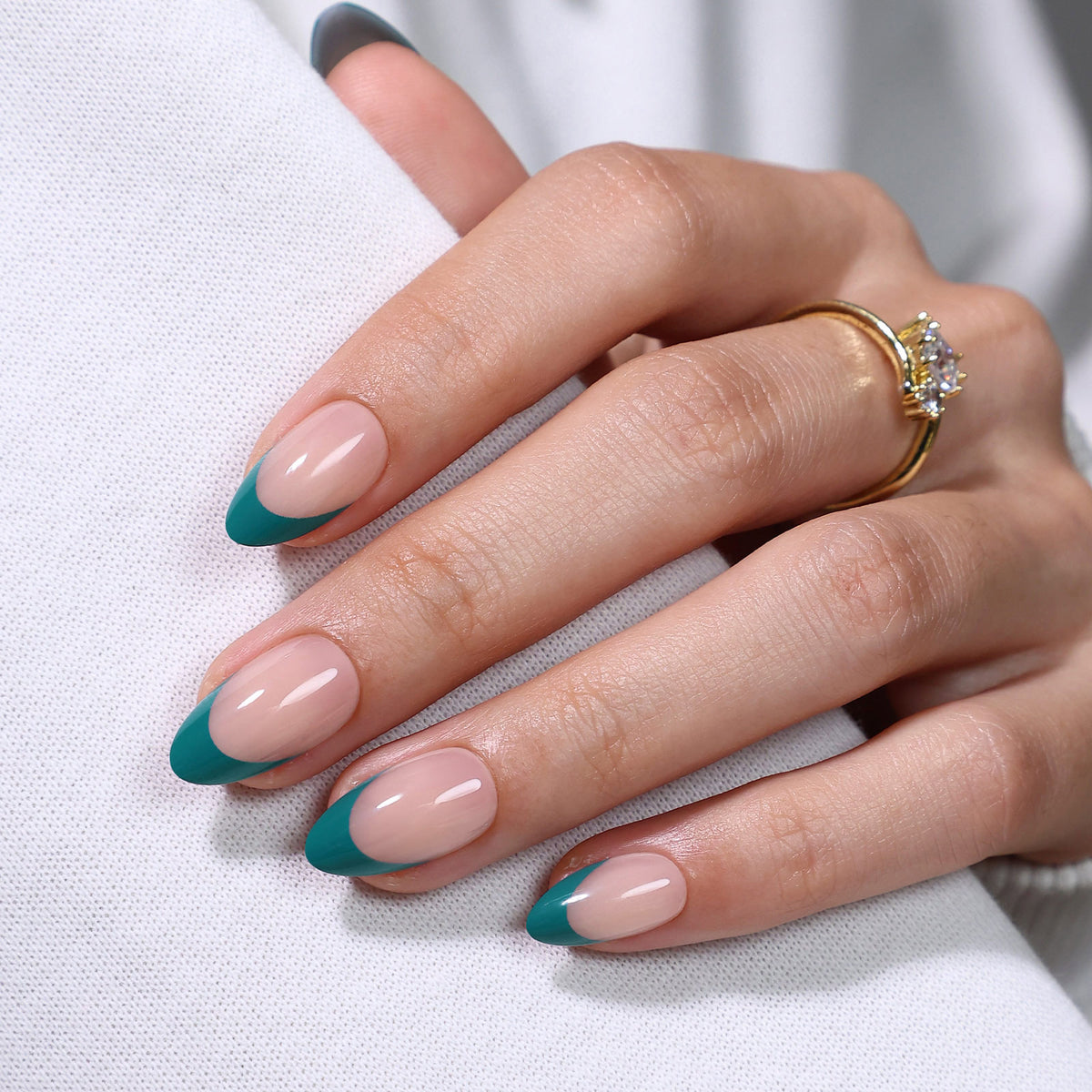 Dark Cyan French Tip Short Almond Press on Nails hand gripping white fabric showing almond shape length | SHANGMENG®