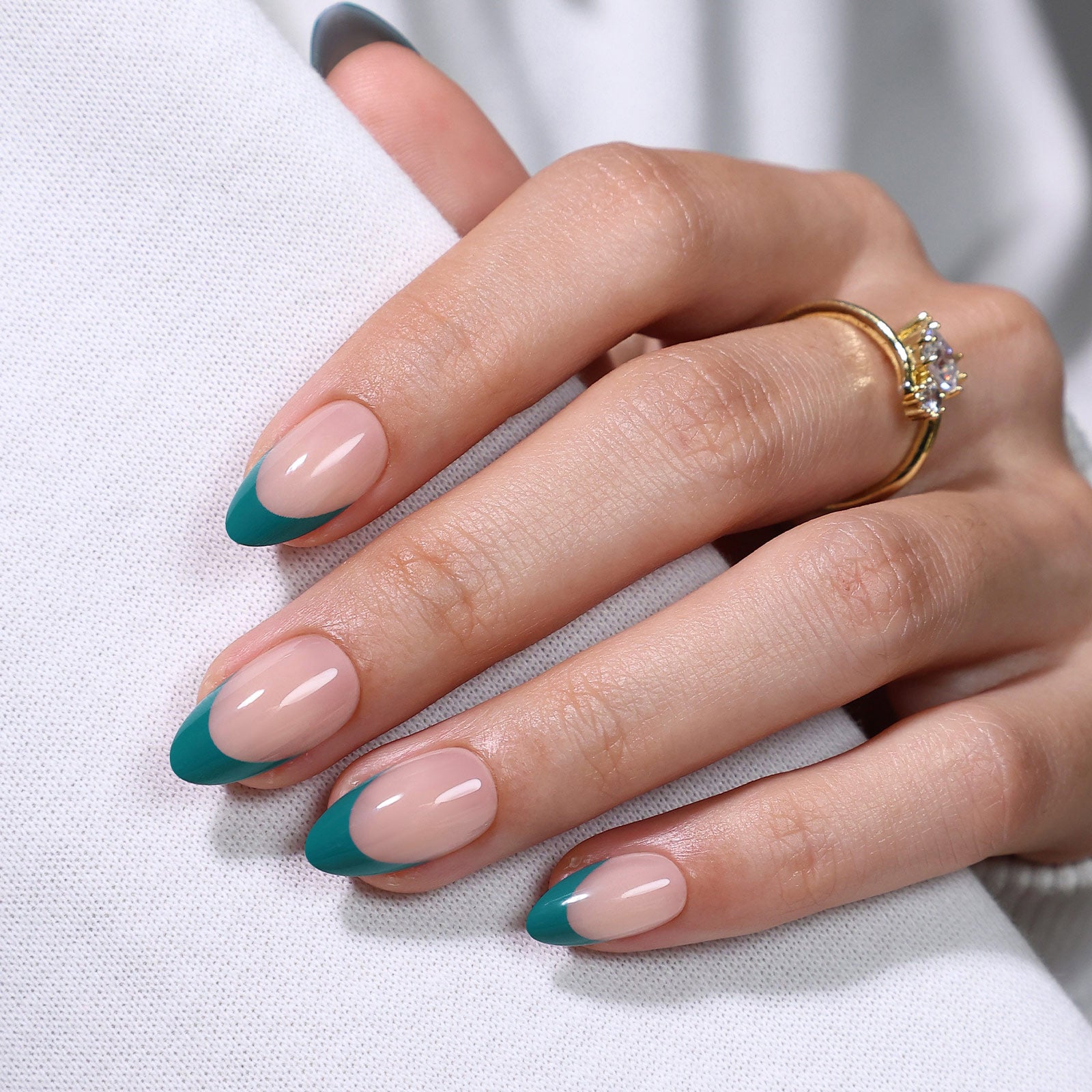 Dark Cyan French Tip Short Almond Press on Nails hand gripping white fabric showing almond shape length | SHANGMENG®