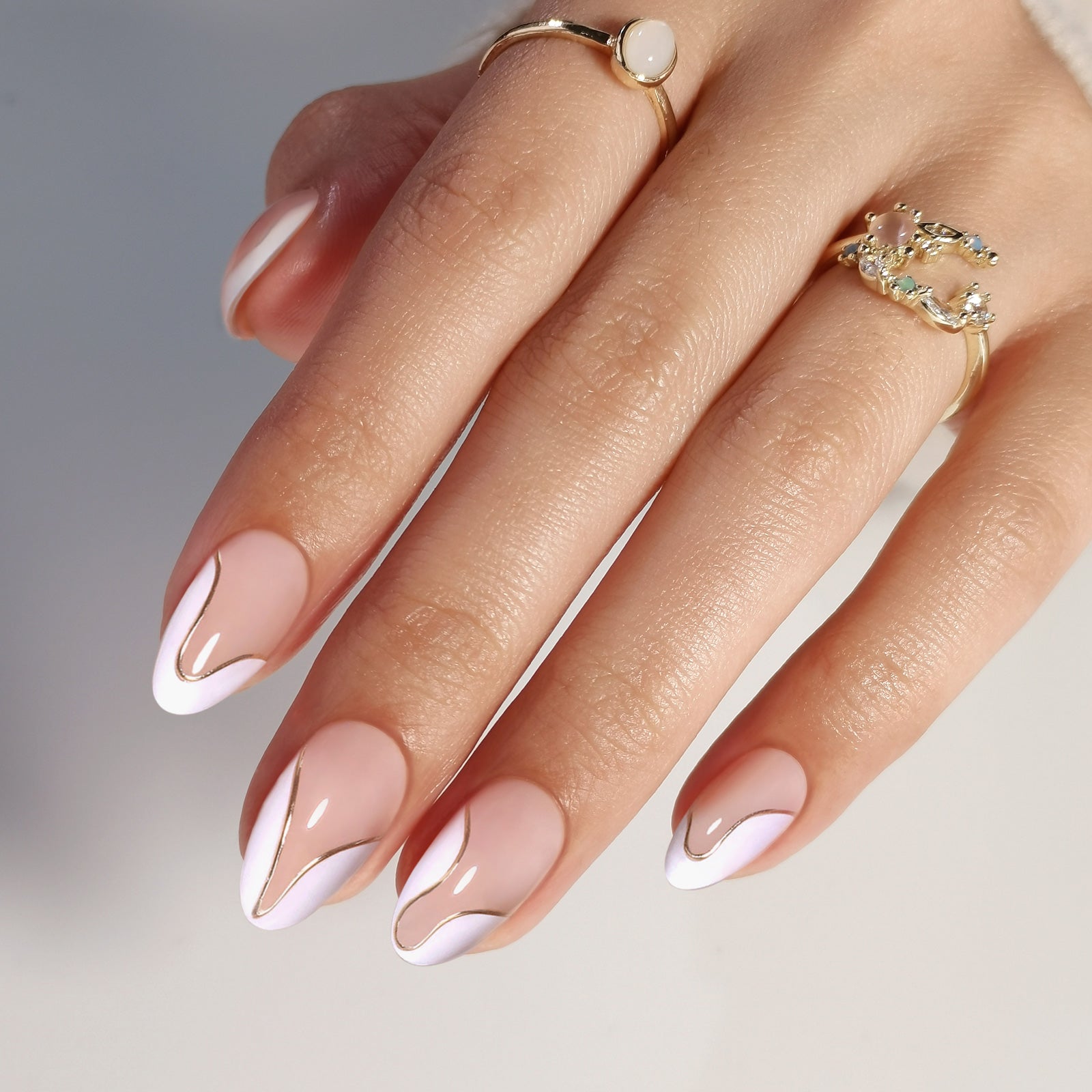 French Tip Gold Almond Reusable Soft Gel Press-On Nails angled hand view | SHANGMENG®