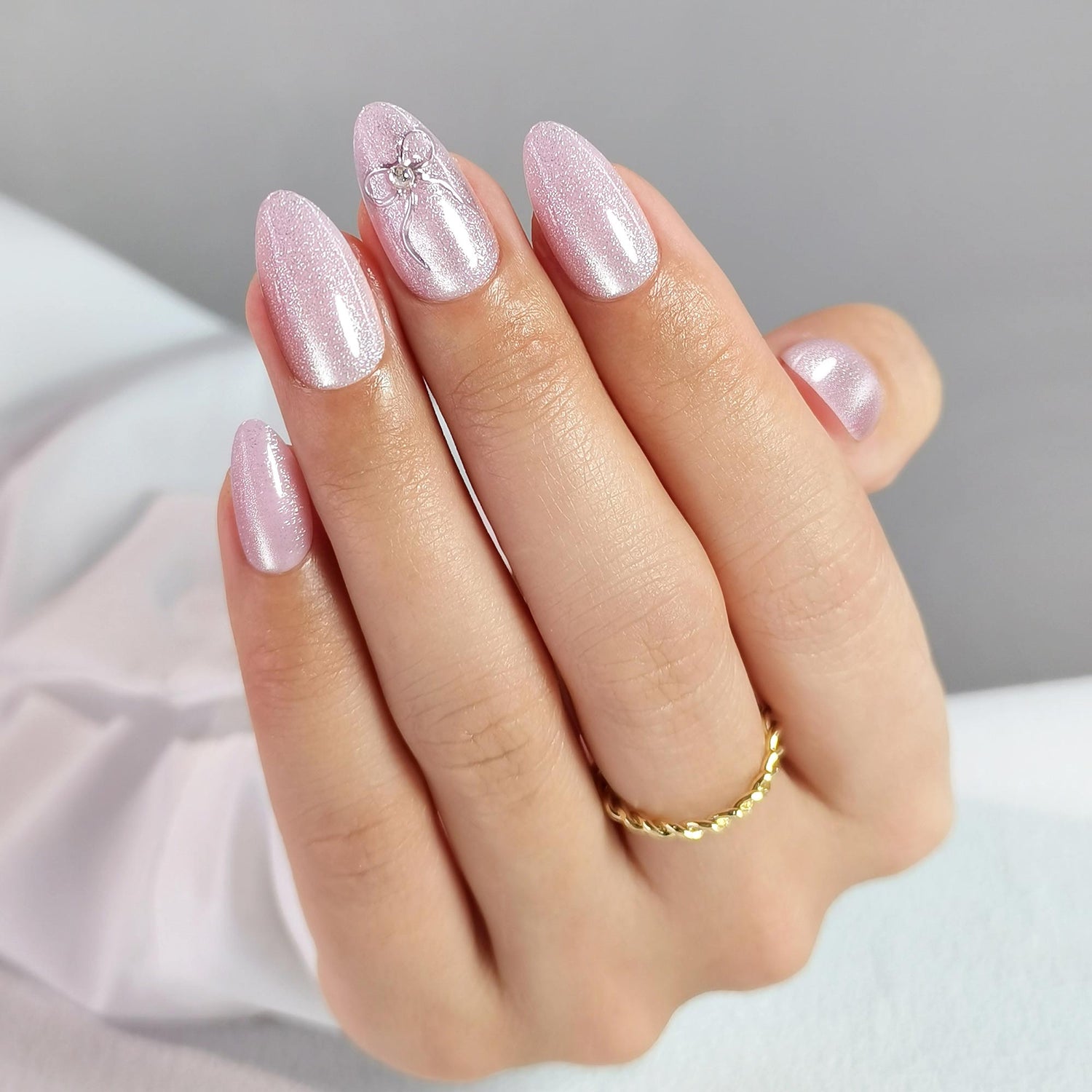 Pink Cat Eye Almond Nails With 3d Silver Bow
