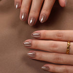 Mocha Mirage Chrome — Extra Short Almond two hands on brown fabric | SHANGMENG®