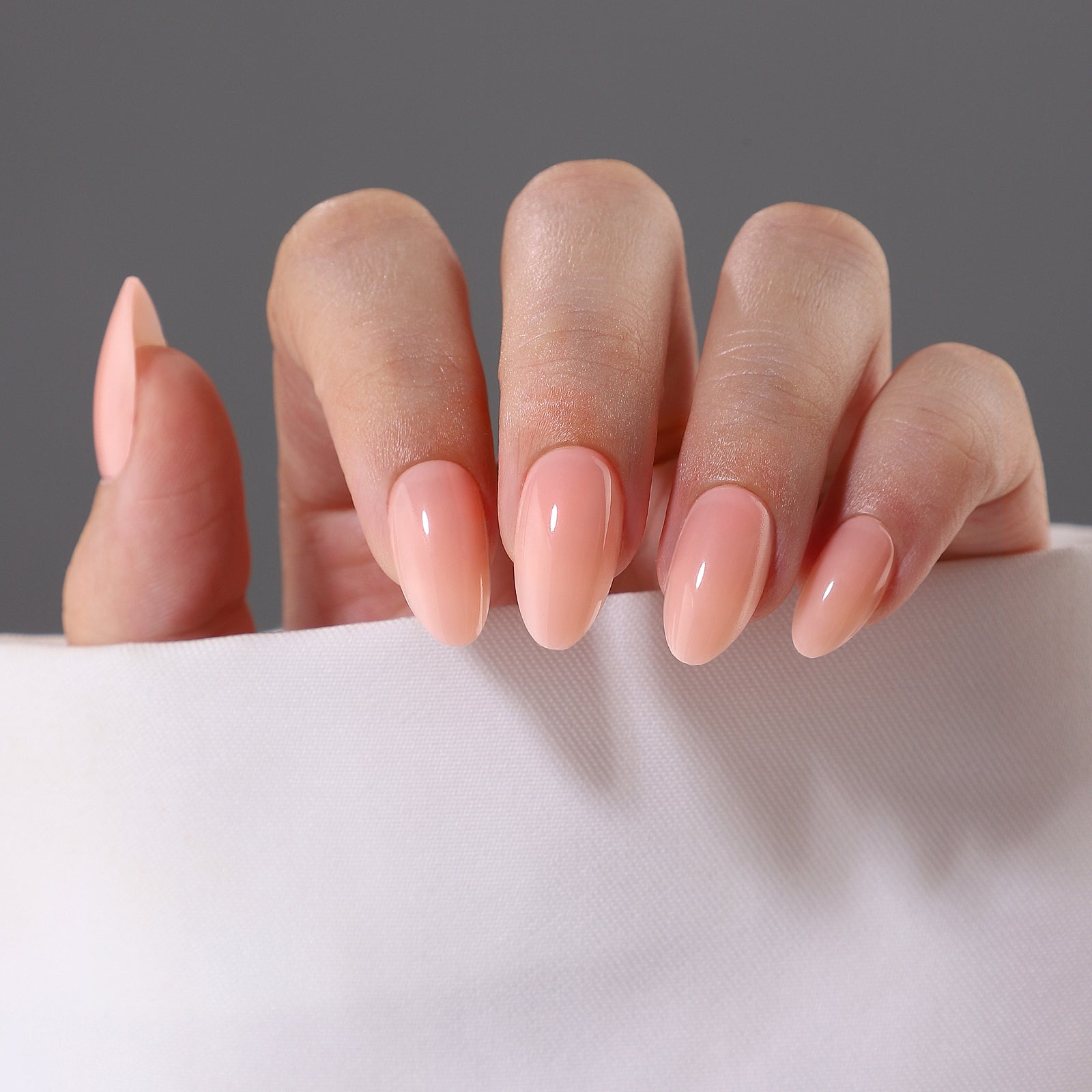 Pink Nude Short Almond Reusable Soft Gel Press-On Nails angled hand view | SHANGMENG®