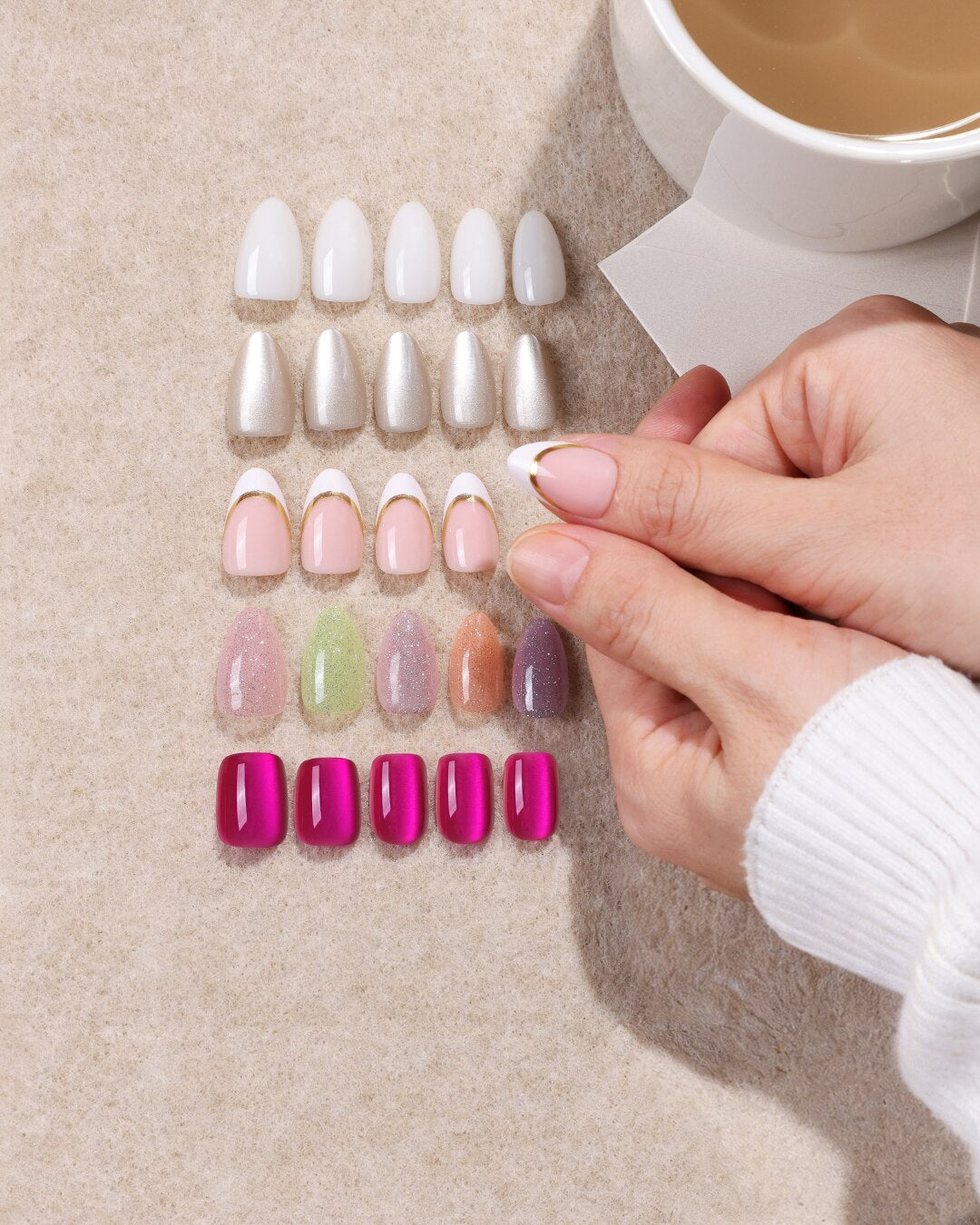 Two hands with SHANGMENG press-on nails beside five sets in white, pearl, gold-line French, glitter and magenta chrome