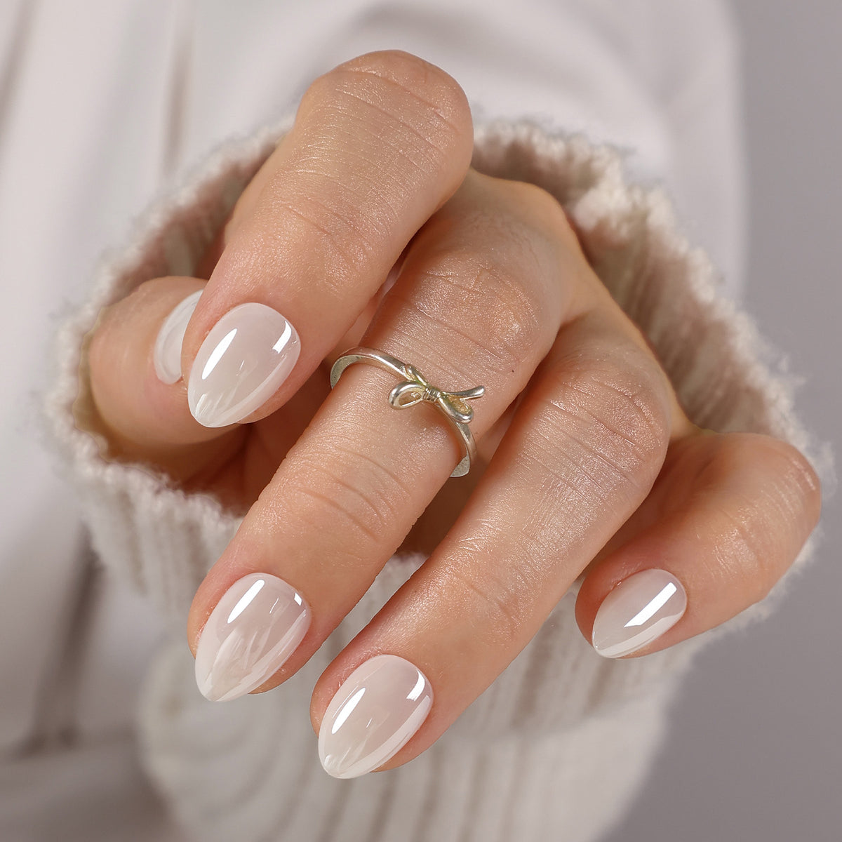 White Mirror Chrome Extra Short Almond Press-On Nails alternate hand angle with knit sleeve | SHANGMENG®